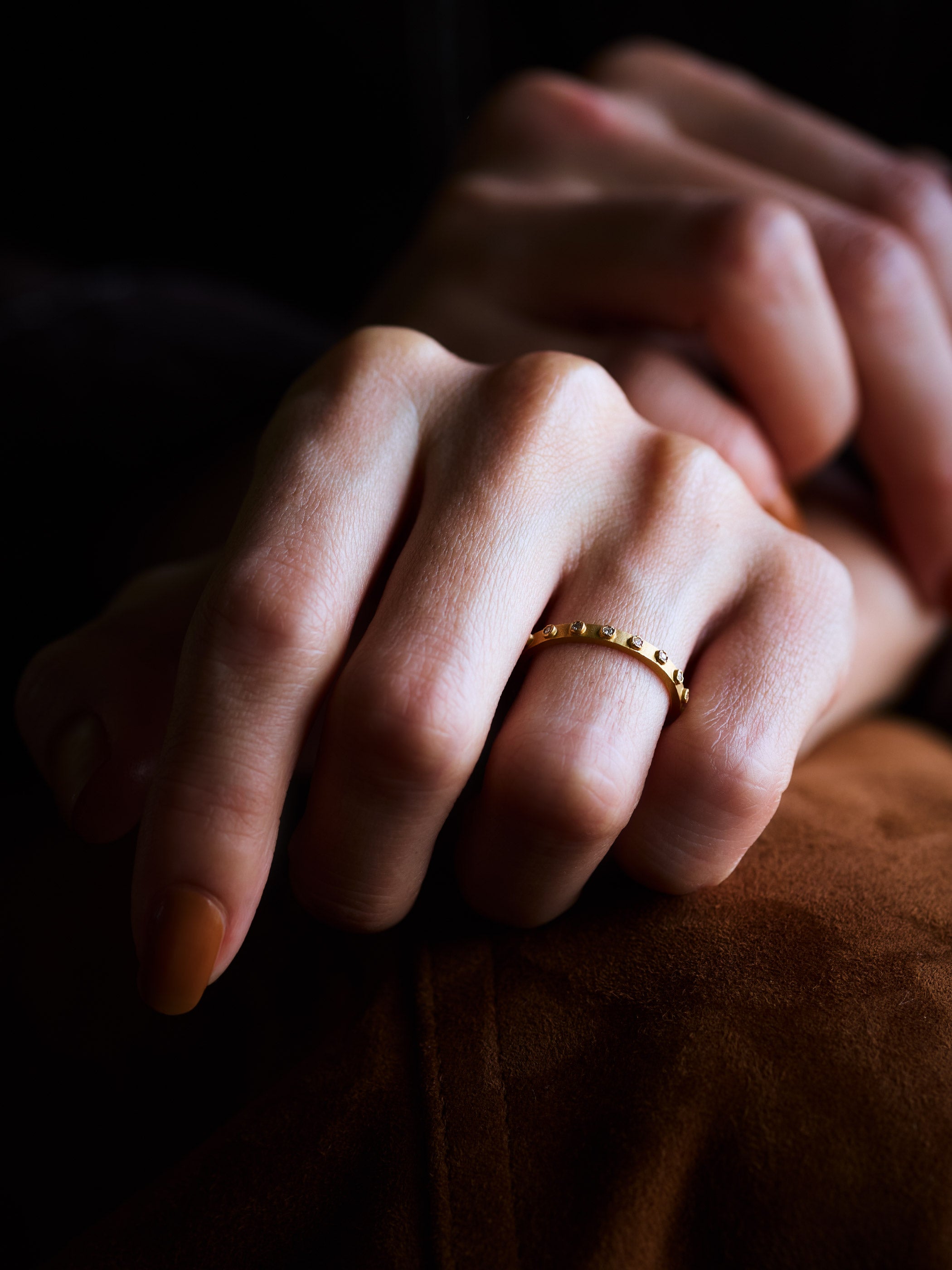 細めのリング幅ながらネオン電飾に見立てたダイヤモンドの石留め。ひとつ身に着けるだけで存在感を感じていただけます *K18YGを着用